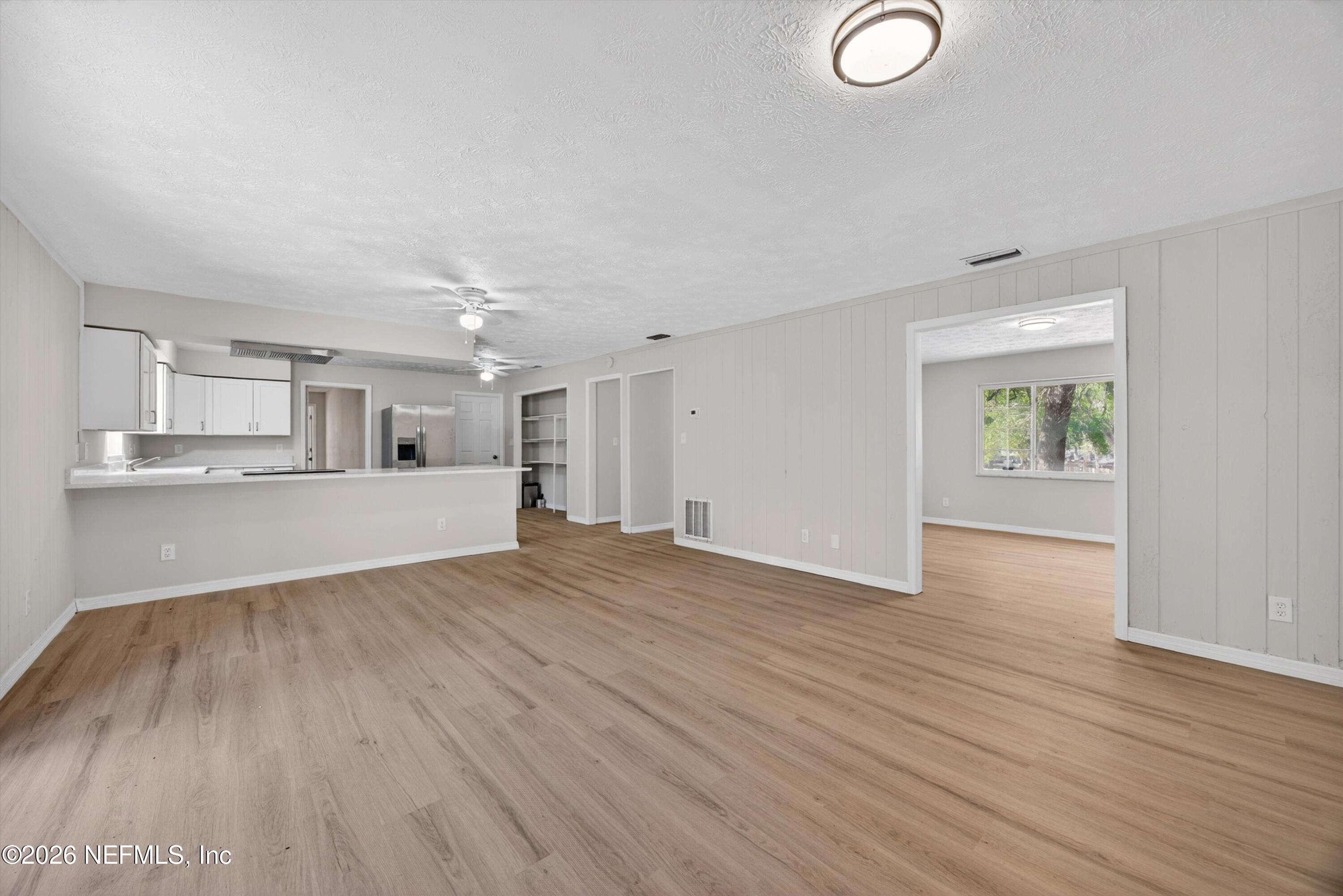 6894 Ridge Street Keystone Heights, FL 32656 - Photo 12 of 40 an empty room with wooden floor and windows