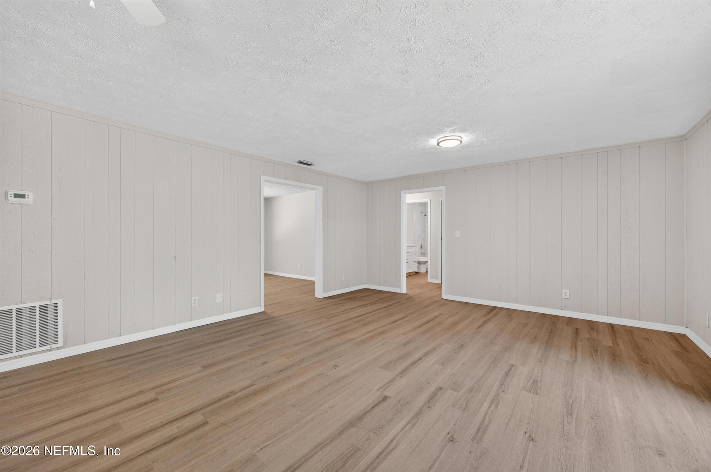 6894 Ridge Street Keystone Heights, FL 32656 - Photo 14 of 40 a view of an empty room with wooden floor