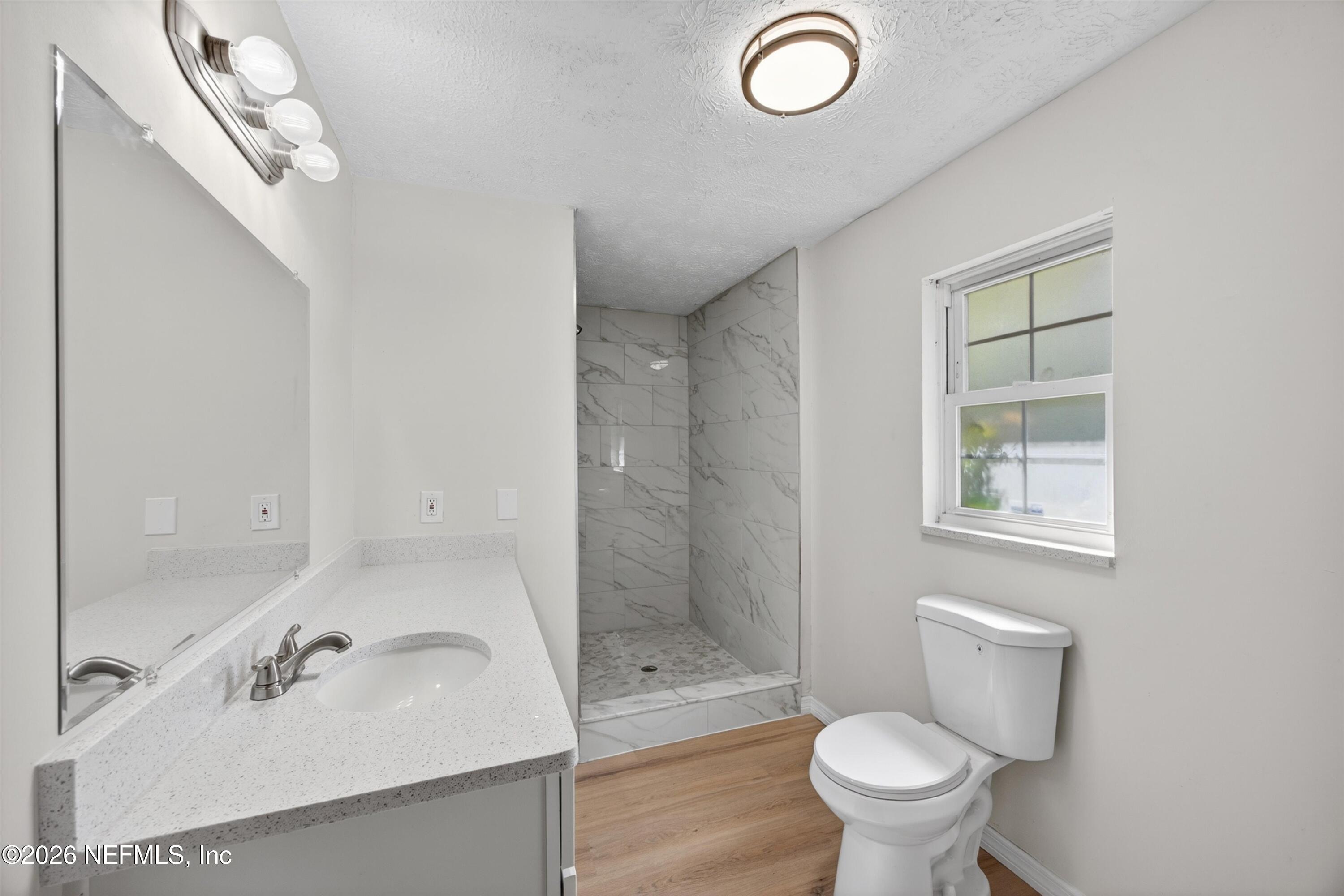 6894 Ridge Street Keystone Heights, FL 32656 - Photo 23 of 40 a bathroom with a sink a toilet and shower