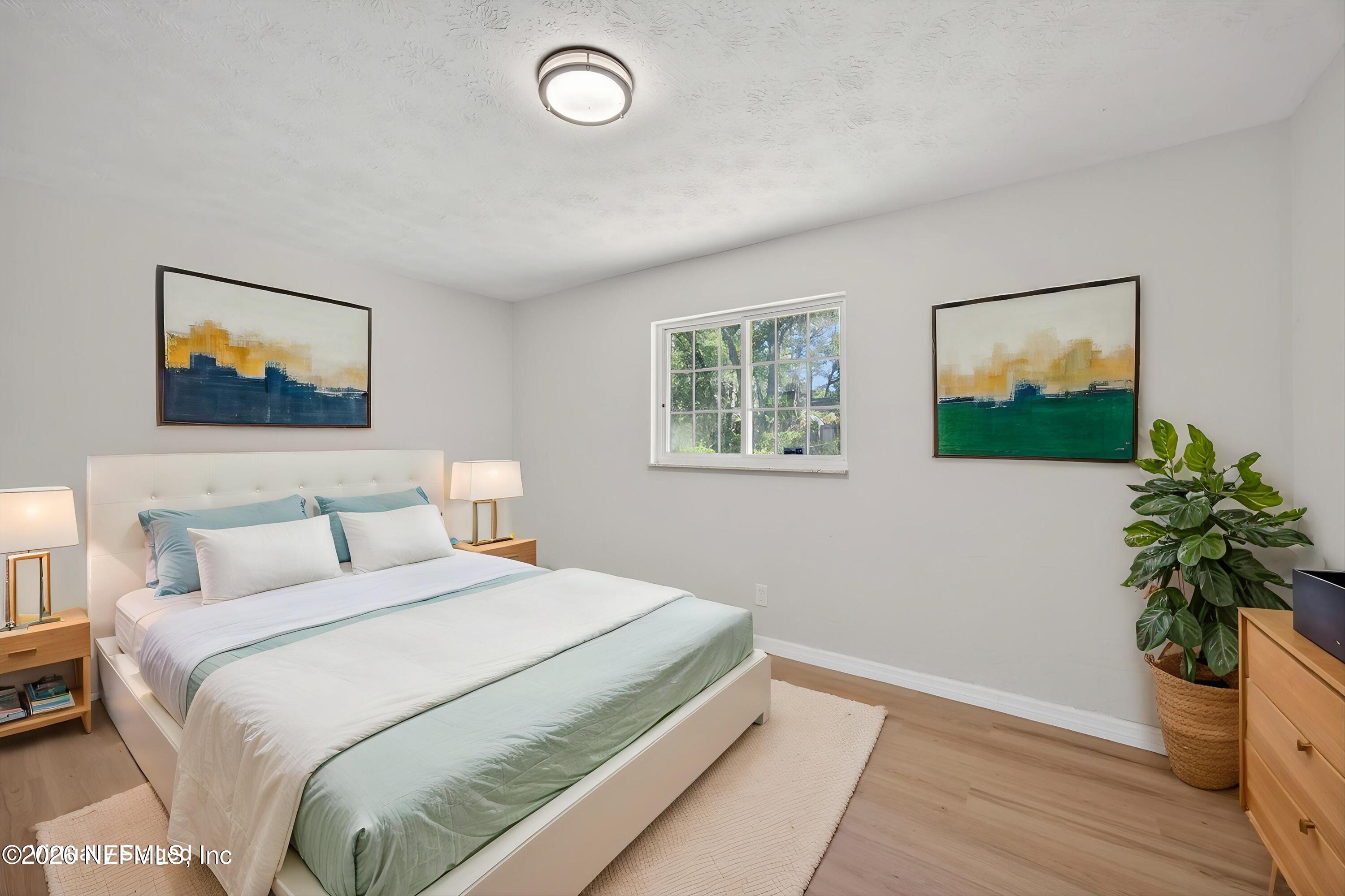 6894 Ridge Street Keystone Heights, FL 32656 - Photo 25 of 40 a bedroom with a bed and a painting on the wall