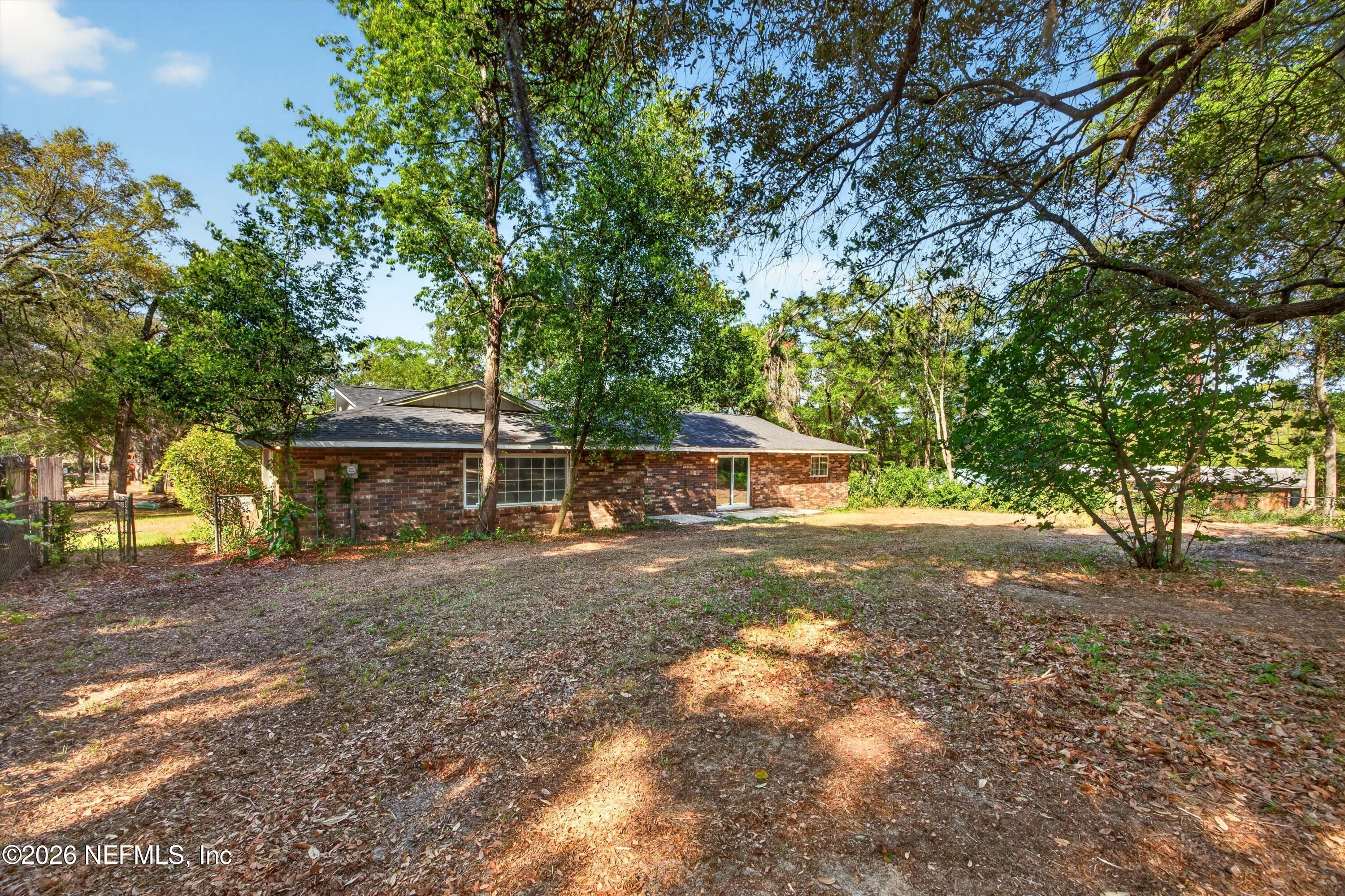 6894 Ridge Street Keystone Heights, FL 32656 - Photo 34 of 40 a view of a yard with a house and a tree