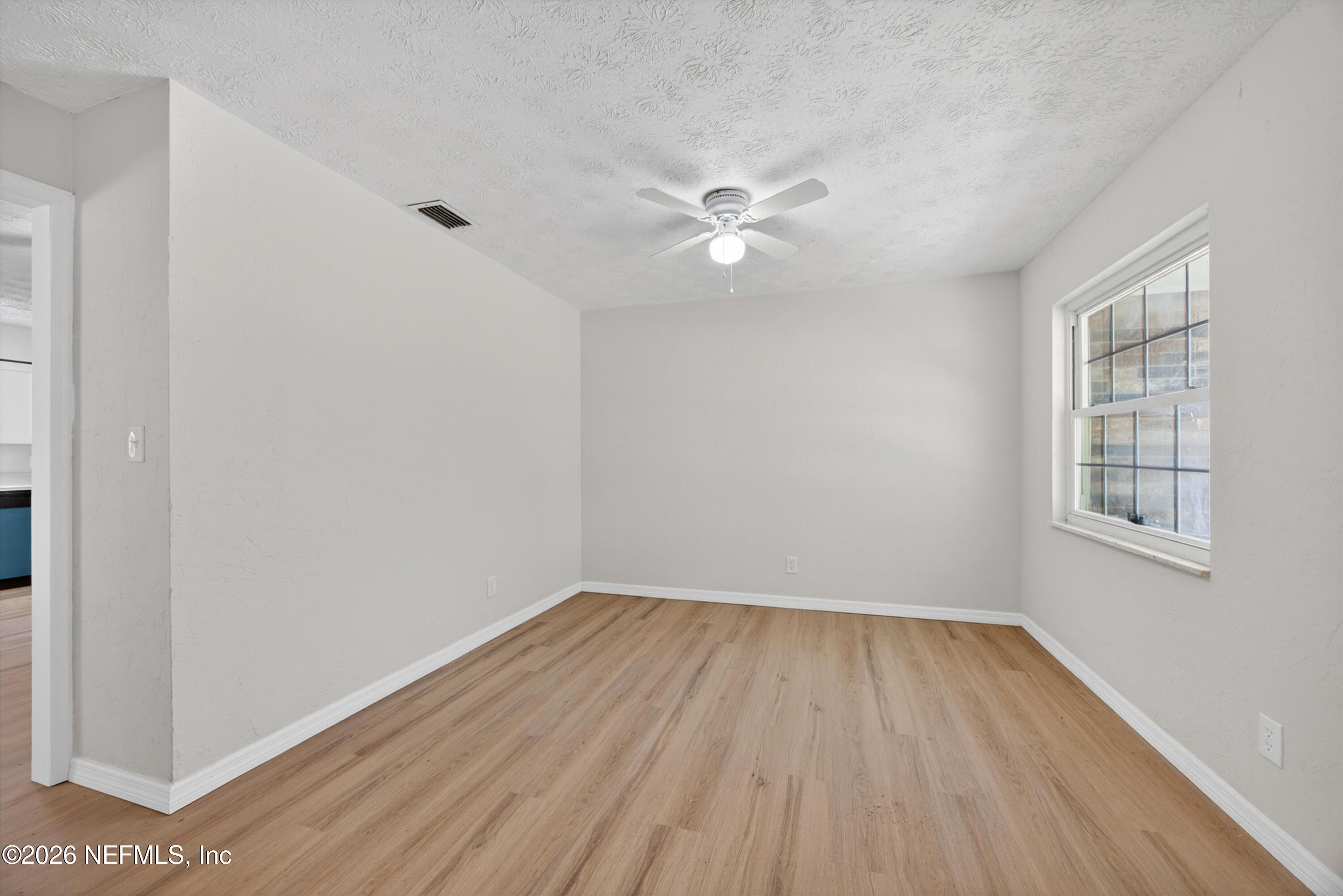 6894 Ridge Street Keystone Heights, FL 32656 - Photo 8 of 40 wooden floor in an empty room with a window