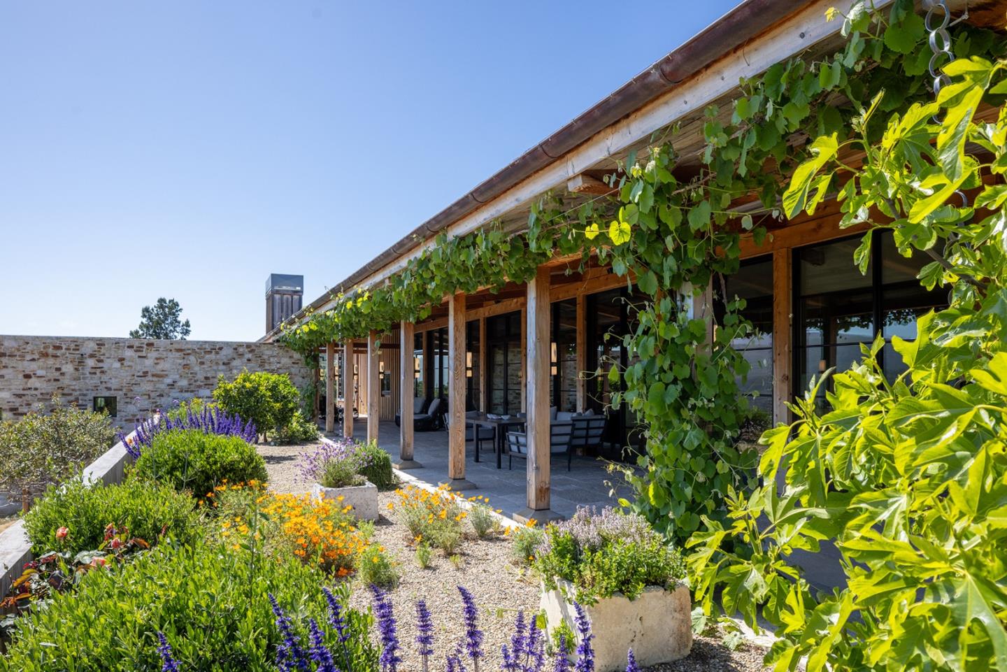 11 Alta Madera Carmel, CA 93923 - Photo 3 of 24 front view of a house with a large window and potted plants