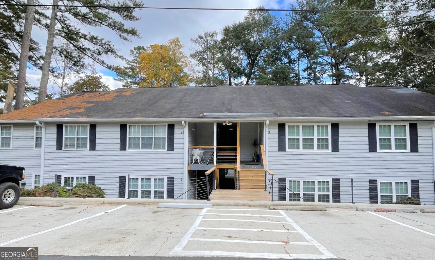 a front view of a house with a garden and garage