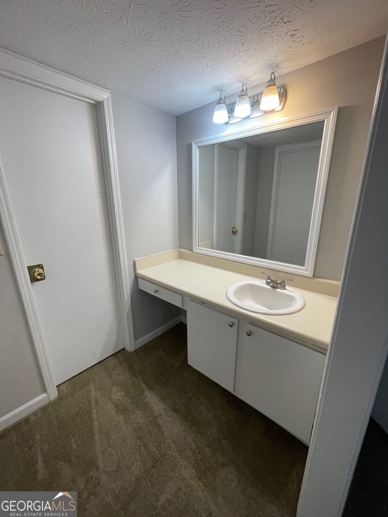 155 Bowen Street, Unit 9 Carrollton, GA 30117 - Photo 21 of 25 a bathroom with a sink and a mirror
