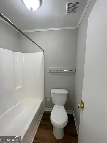 a bathroom with a toilet and a bathtub