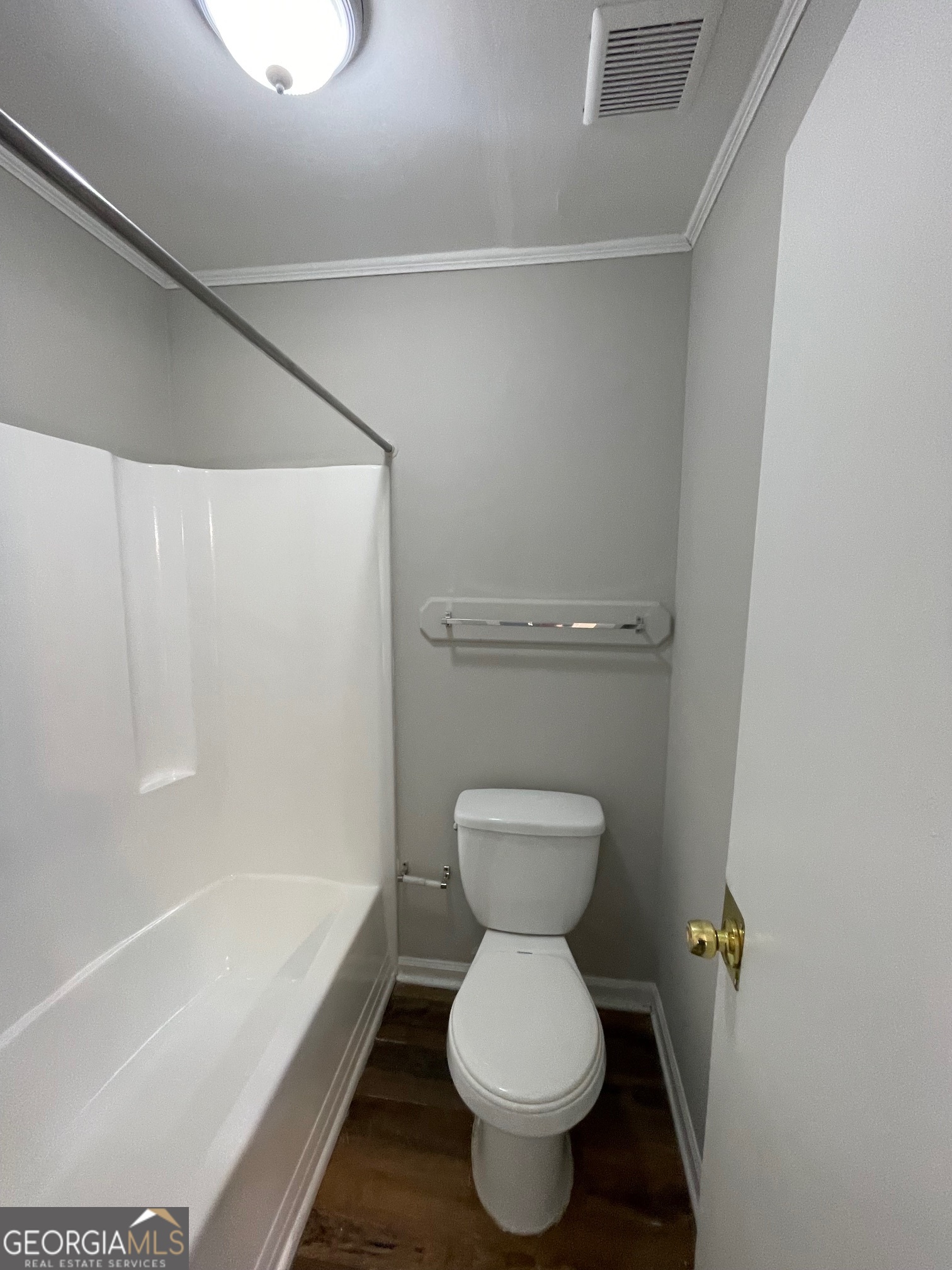 155 Bowen Street, Unit 9 Carrollton, GA 30117 - Photo 22 of 25 a bathroom with a toilet and a bathtub