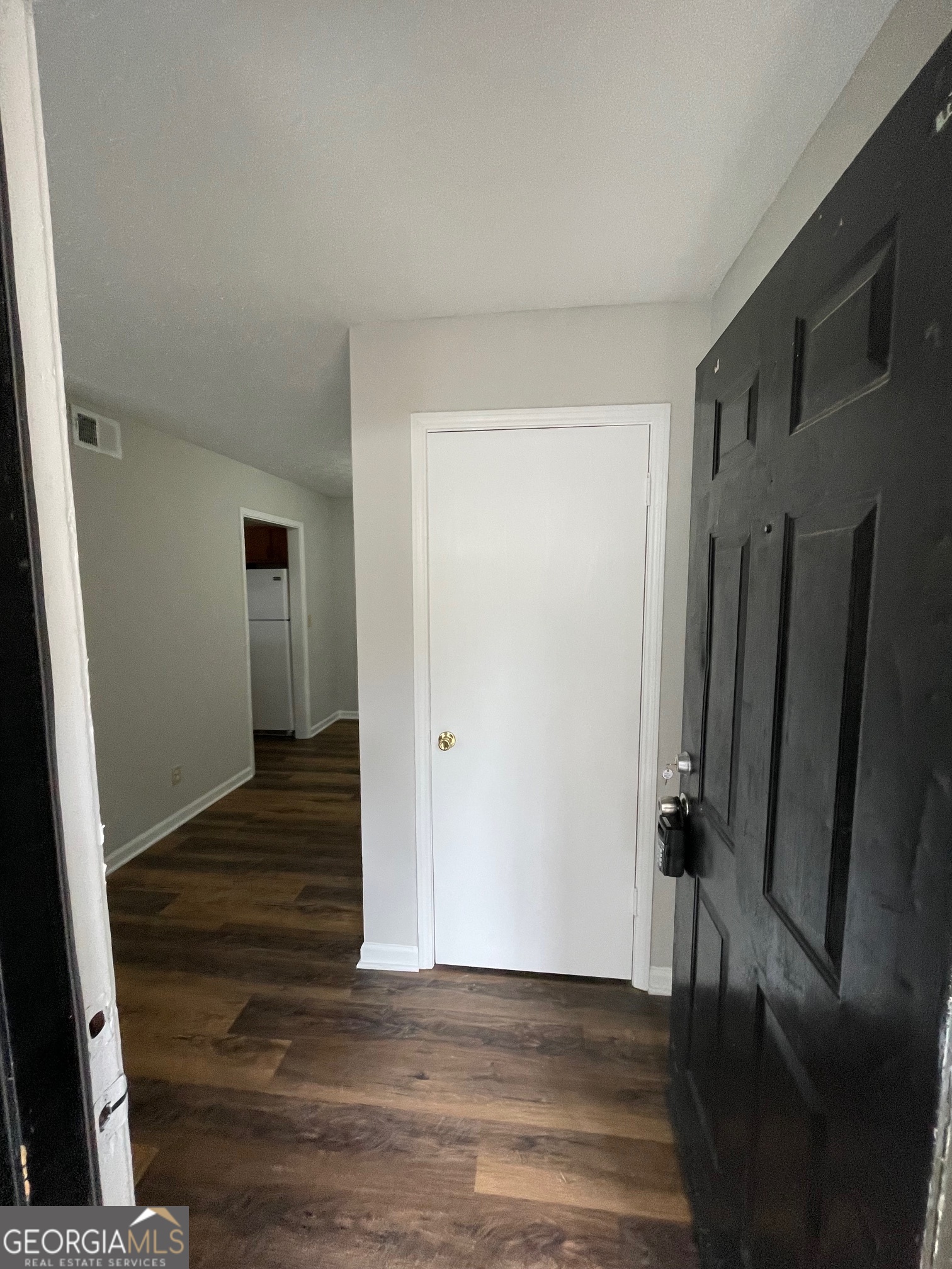 155 Bowen Street, Unit 9 Carrollton, GA 30117 - Photo 3 of 25 a view of a hallway with wooden floor and staircase