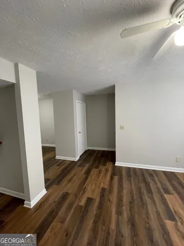 a view of an empty room and wooden floor