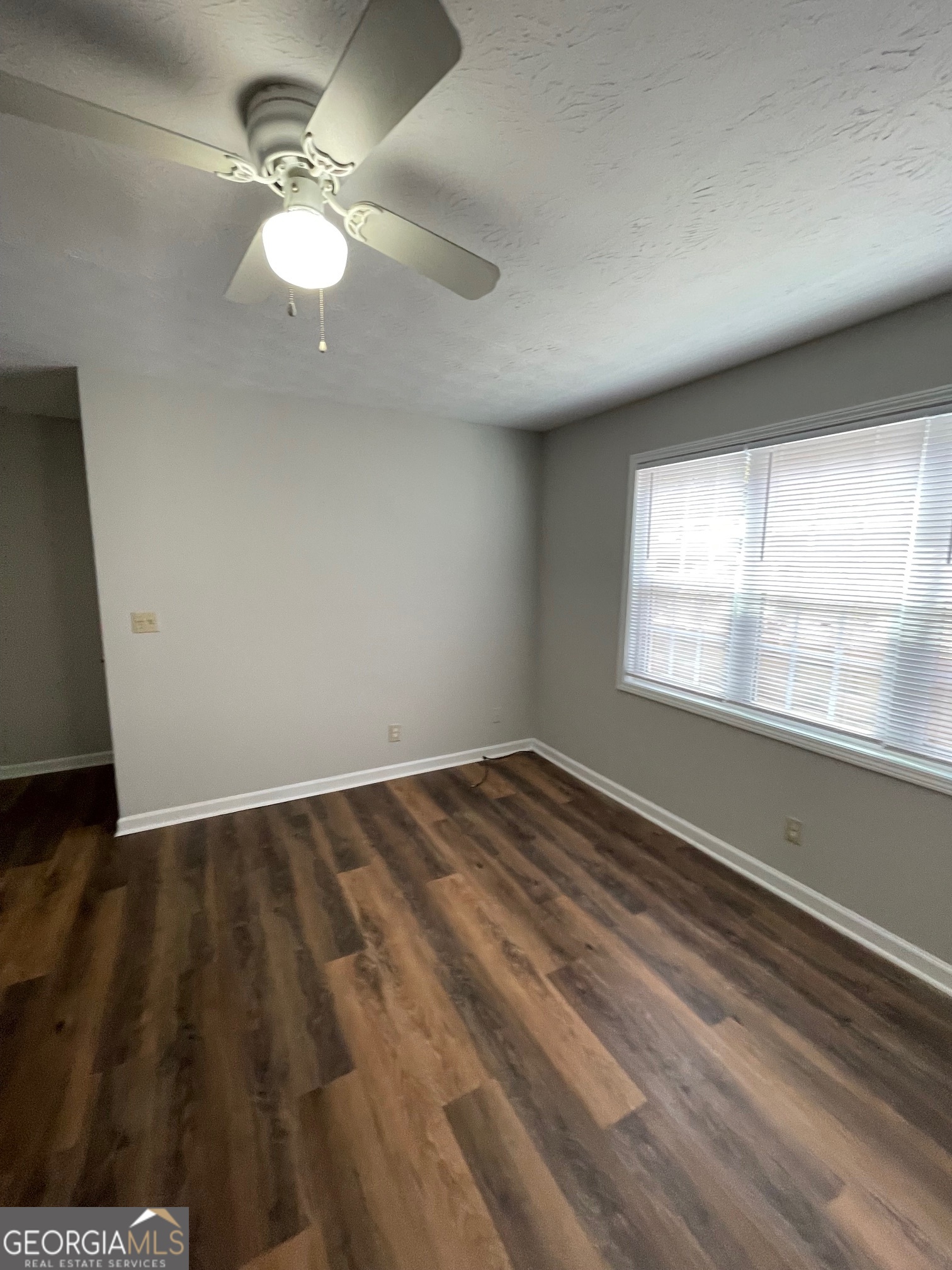 155 Bowen Street, Unit 9 Carrollton, GA 30117 - Photo 7 of 25 wooden floor in an empty room with a window