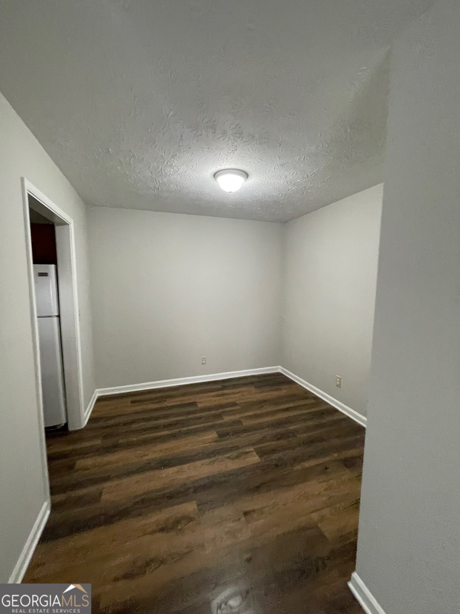 155 Bowen Street, Unit 9 Carrollton, GA 30117 - Photo 9 of 25 a view of room with wooden floor