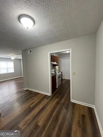 a view of a hallway with wooden floor