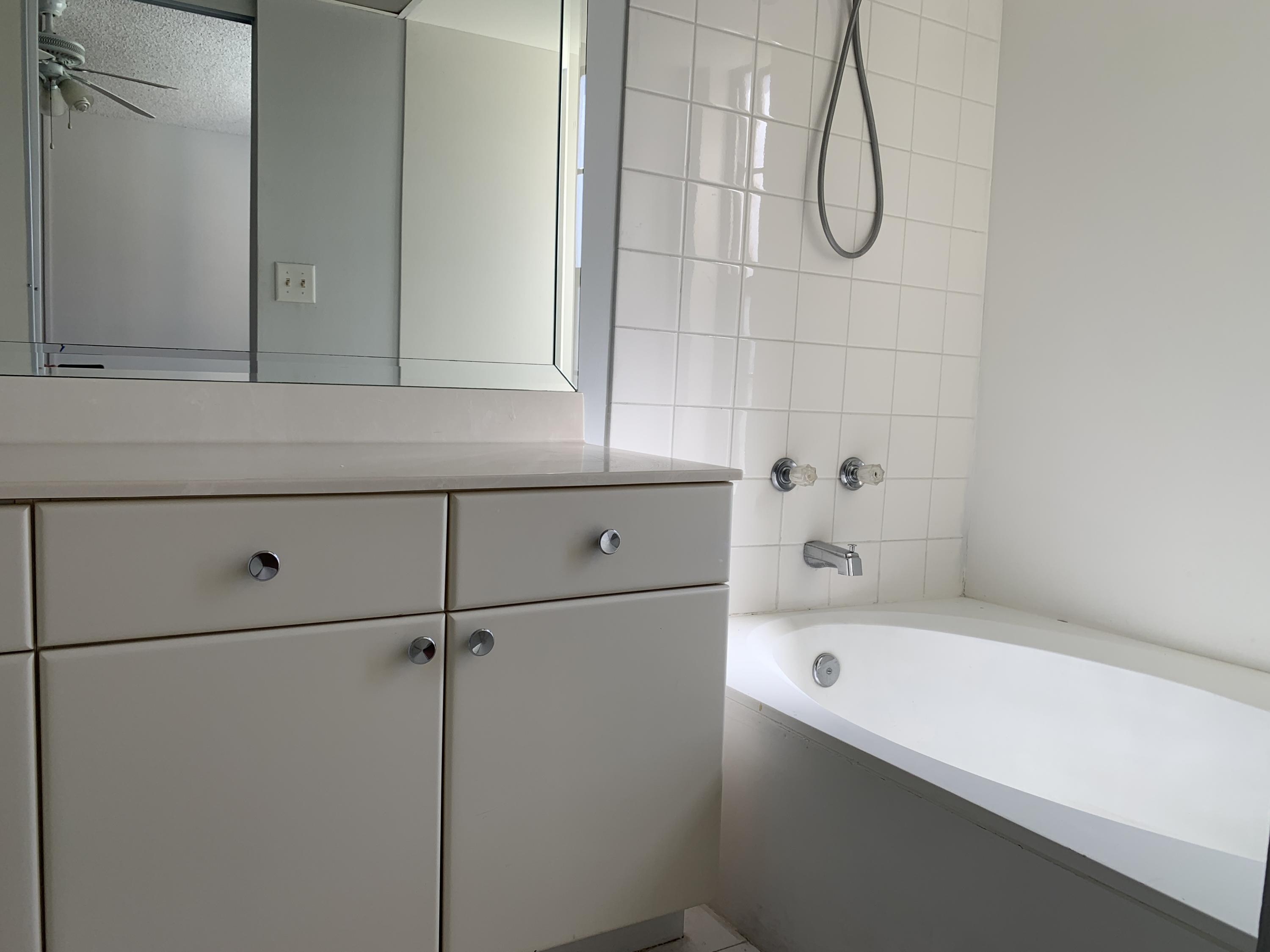 9370 Southwest 8th Street, Unit 202 Boca Raton, FL 33428 - Photo 18 of 46 a bathroom with a bathtub and shower