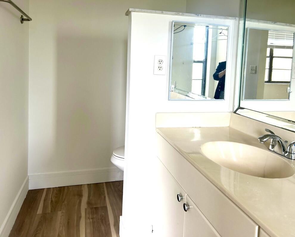 9370 Southwest 8th Street, Unit 202 Boca Raton, FL 33428 - Photo 22 of 46 a bathroom with a sink and a mirror