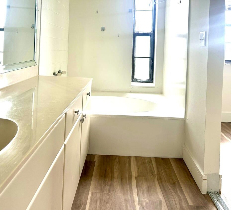 9370 Southwest 8th Street, Unit 202 Boca Raton, FL 33428 - Photo 23 of 46 a bathroom with a bathtub and a sink