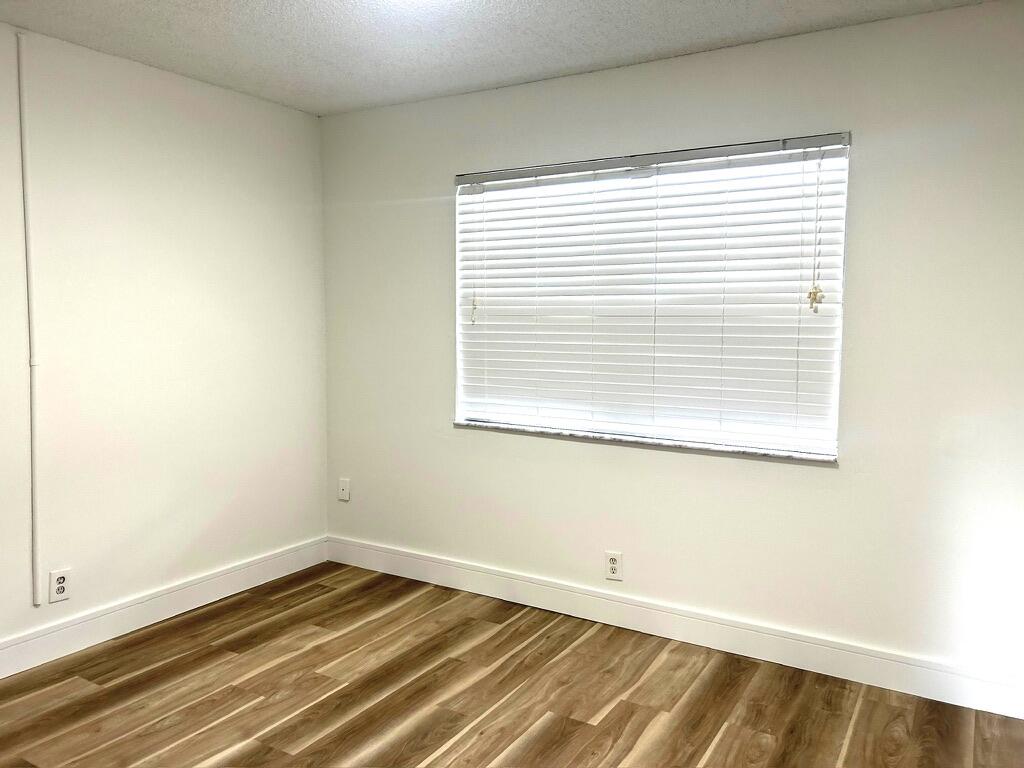 9370 Southwest 8th Street, Unit 202 Boca Raton, FL 33428 - Photo 25 of 46 a view of a room with wooden floor and a window