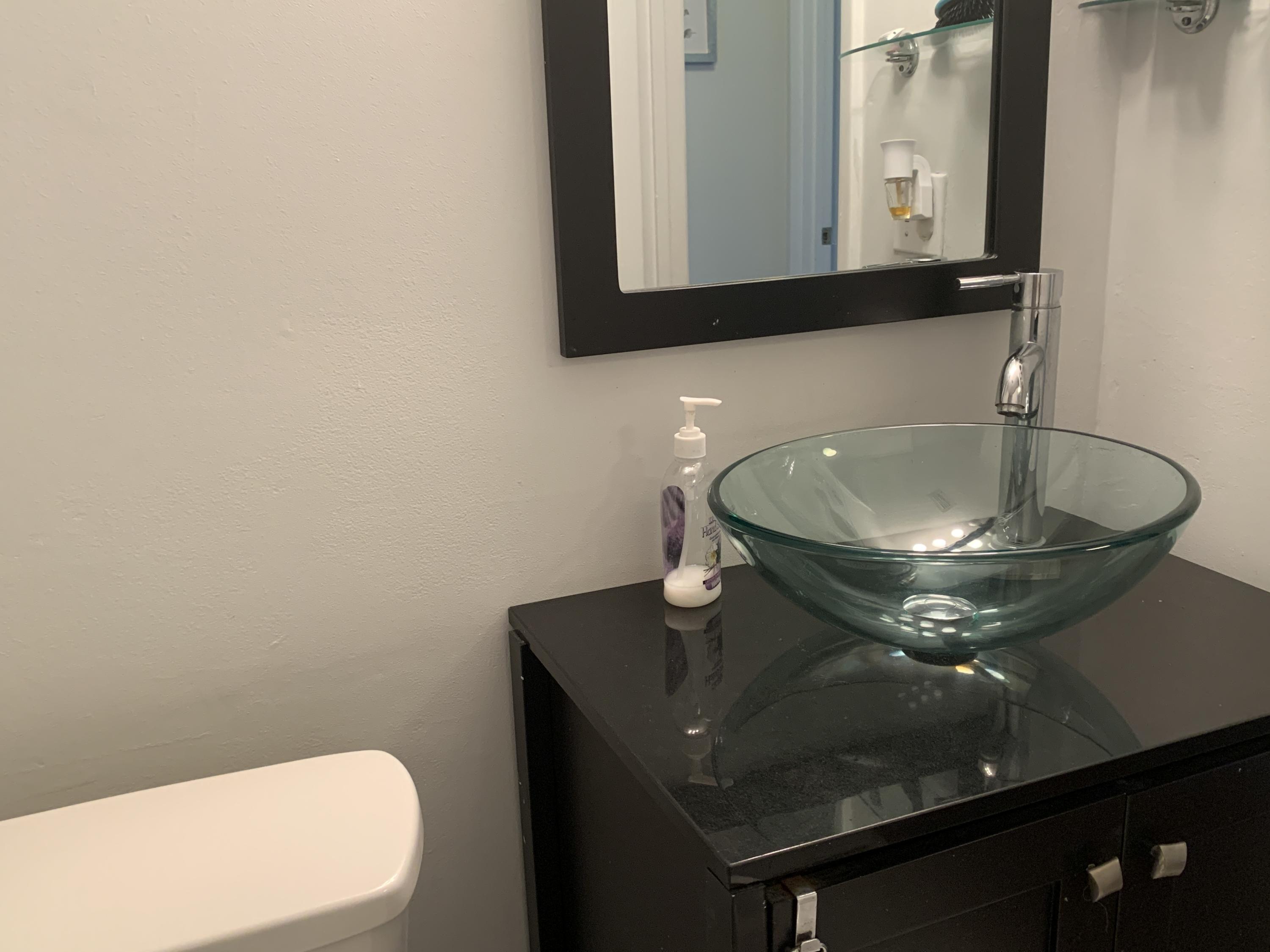 9370 Southwest 8th Street, Unit 202 Boca Raton, FL 33428 - Photo 28 of 46 a bathroom with a sink and a mirror