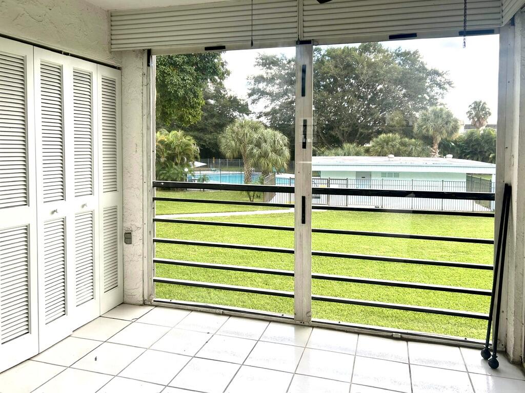 9370 Southwest 8th Street, Unit 202 Boca Raton, FL 33428 - Photo 30 of 46 a view of a porch with a bench