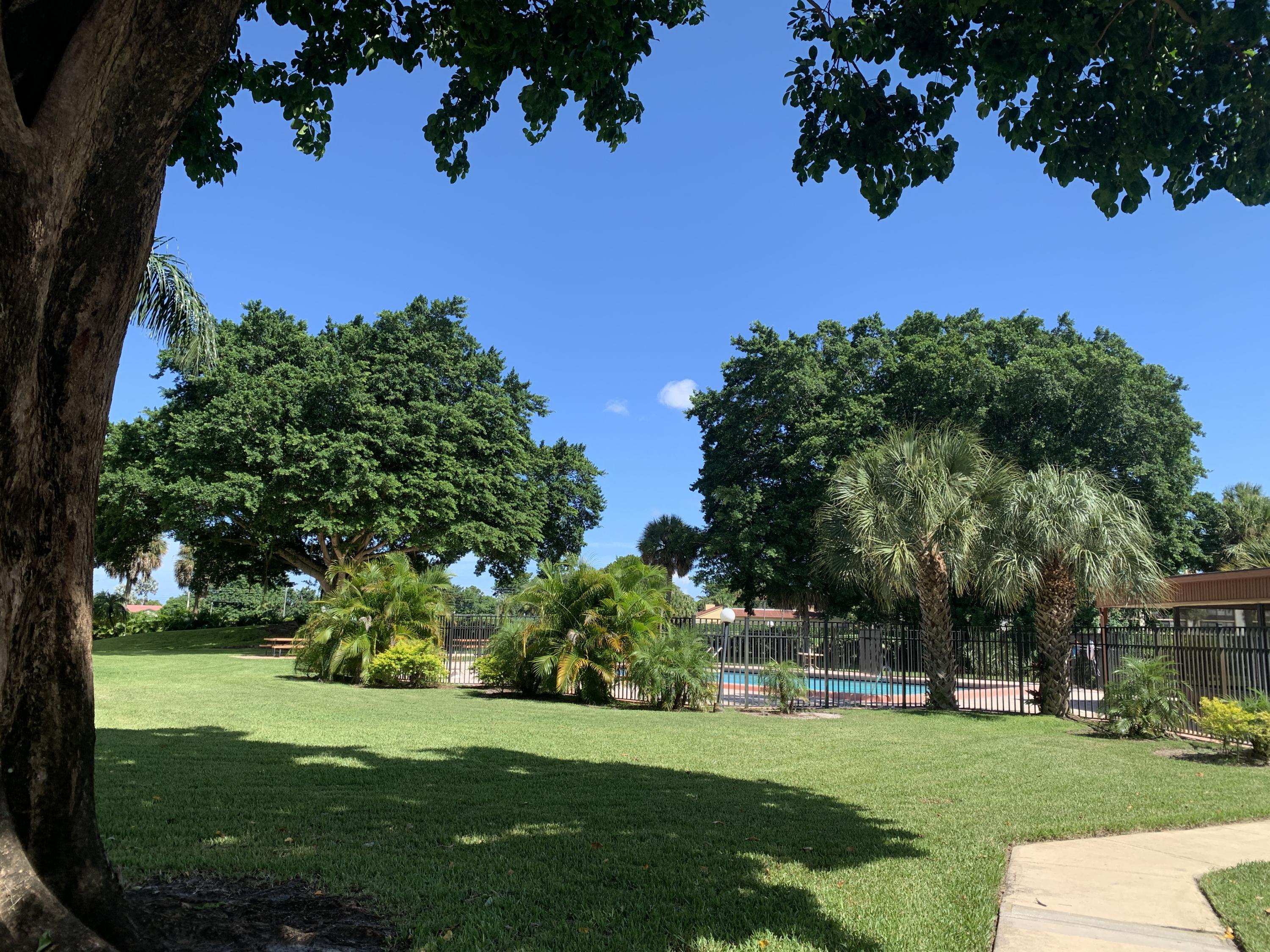 9370 Southwest 8th Street, Unit 202 Boca Raton, FL 33428 - Photo 34 of 46 a view of a golf course with a garden
