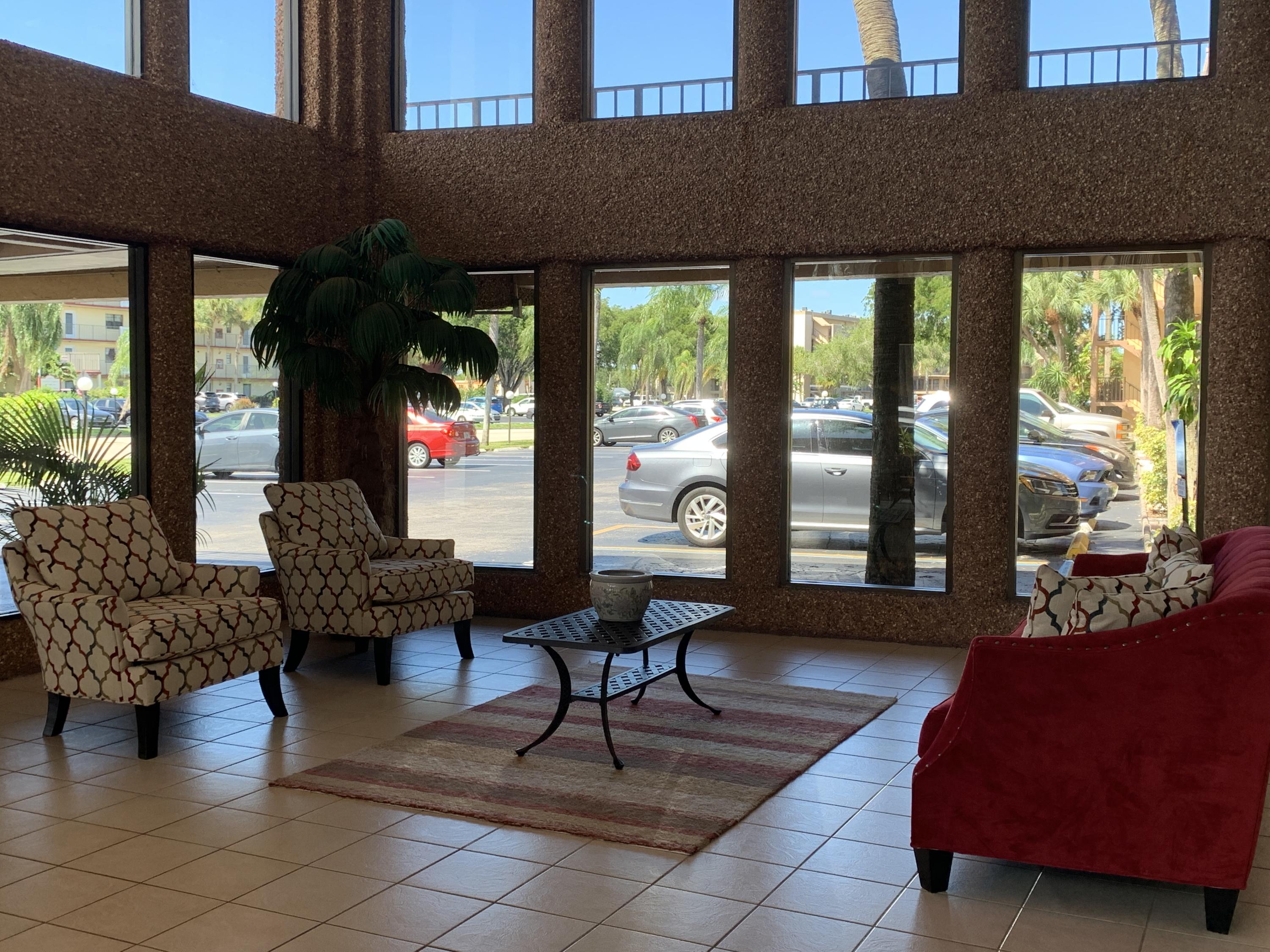 9370 Southwest 8th Street, Unit 202 Boca Raton, FL 33428 - Photo 40 of 46 a living room with furniture and a large window