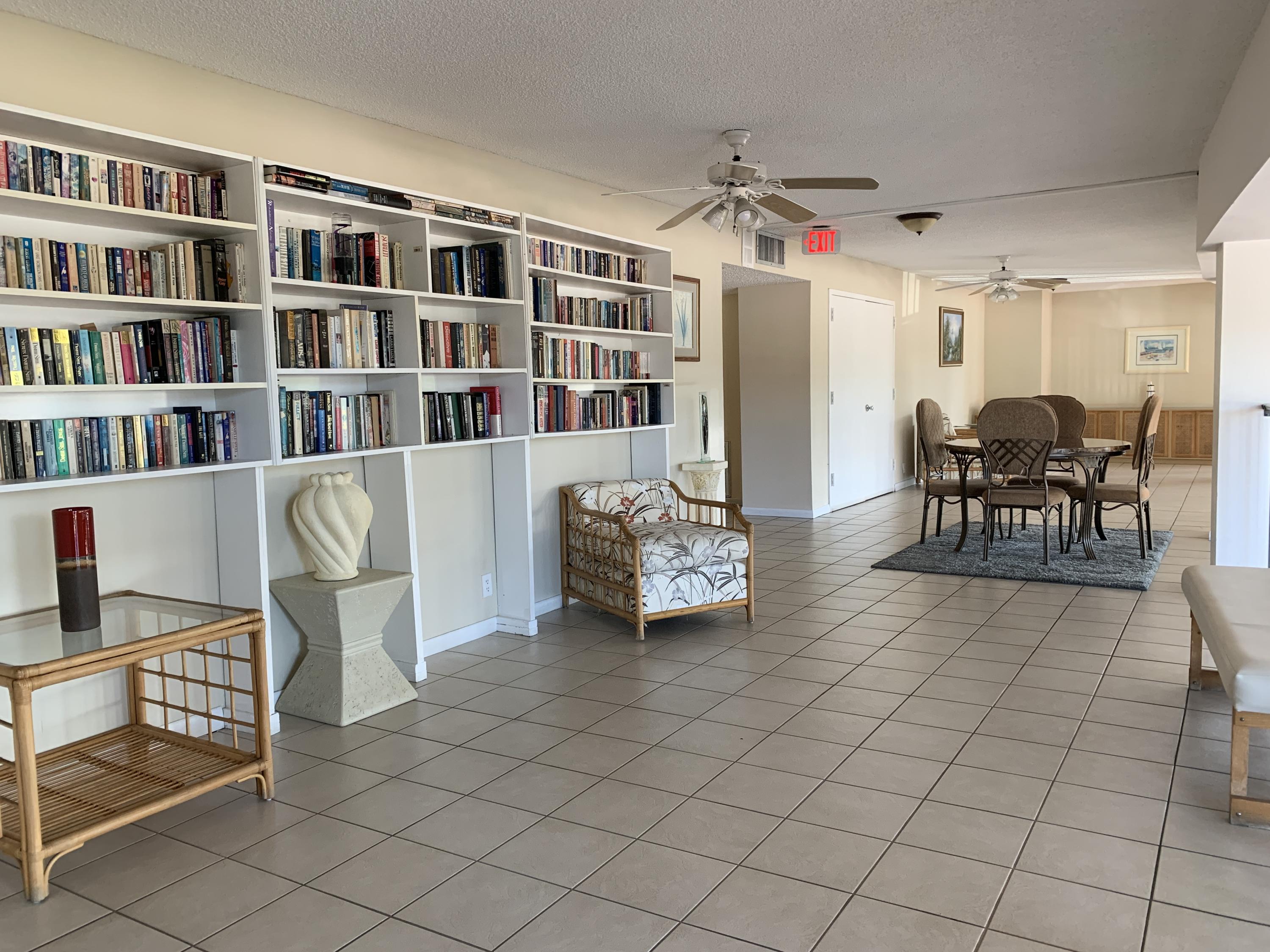9370 Southwest 8th Street, Unit 202 Boca Raton, FL 33428 - Photo 41 of 46 a living room with furniture and a book shelf