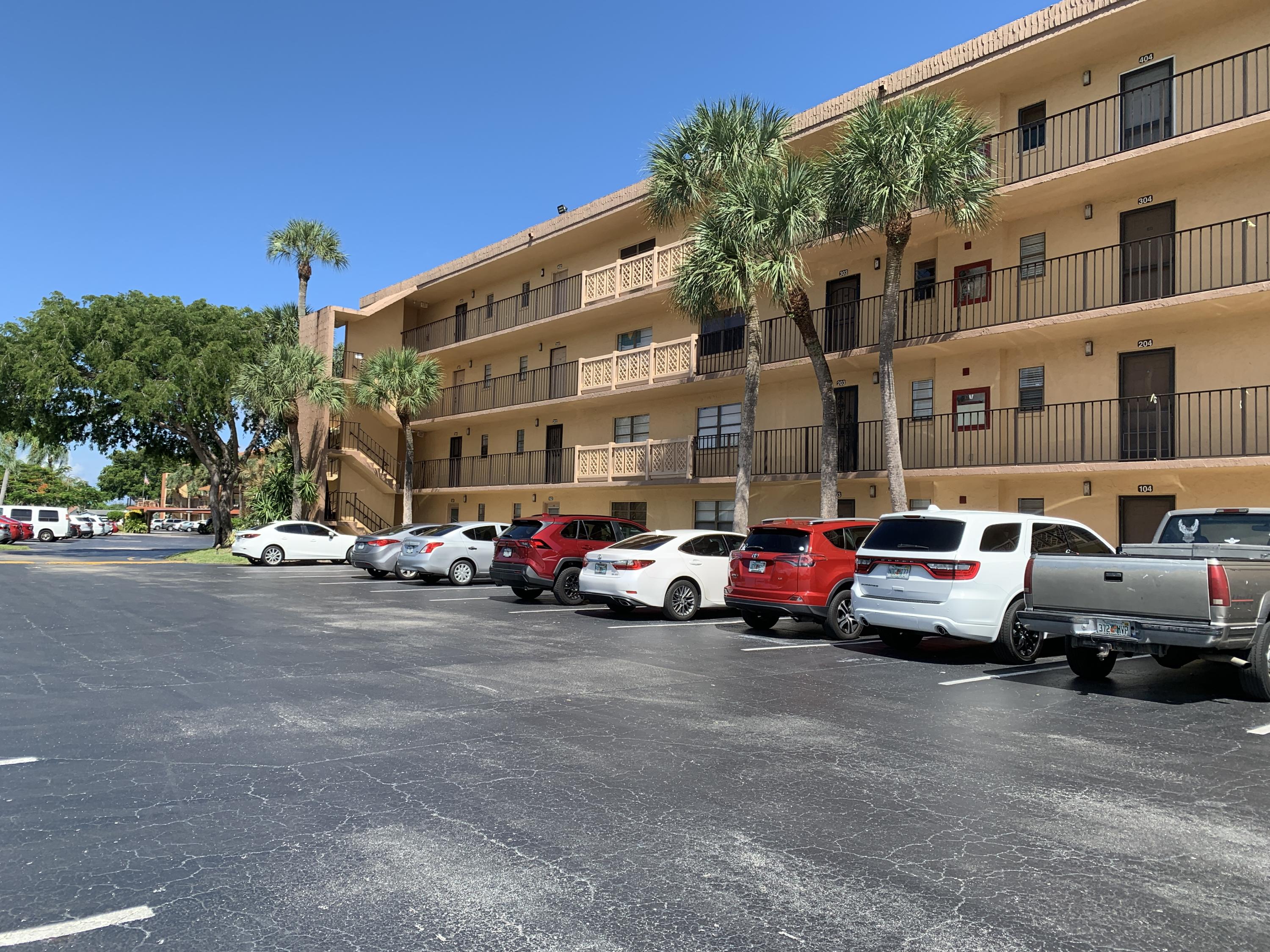 9370 Southwest 8th Street, Unit 202 Boca Raton, FL 33428 - Photo 44 of 46 a view of a cars parked in front of a building