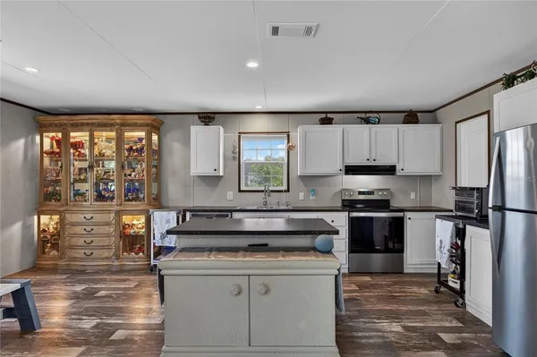 a kitchen with stainless steel appliances a stove sink and refrigerator