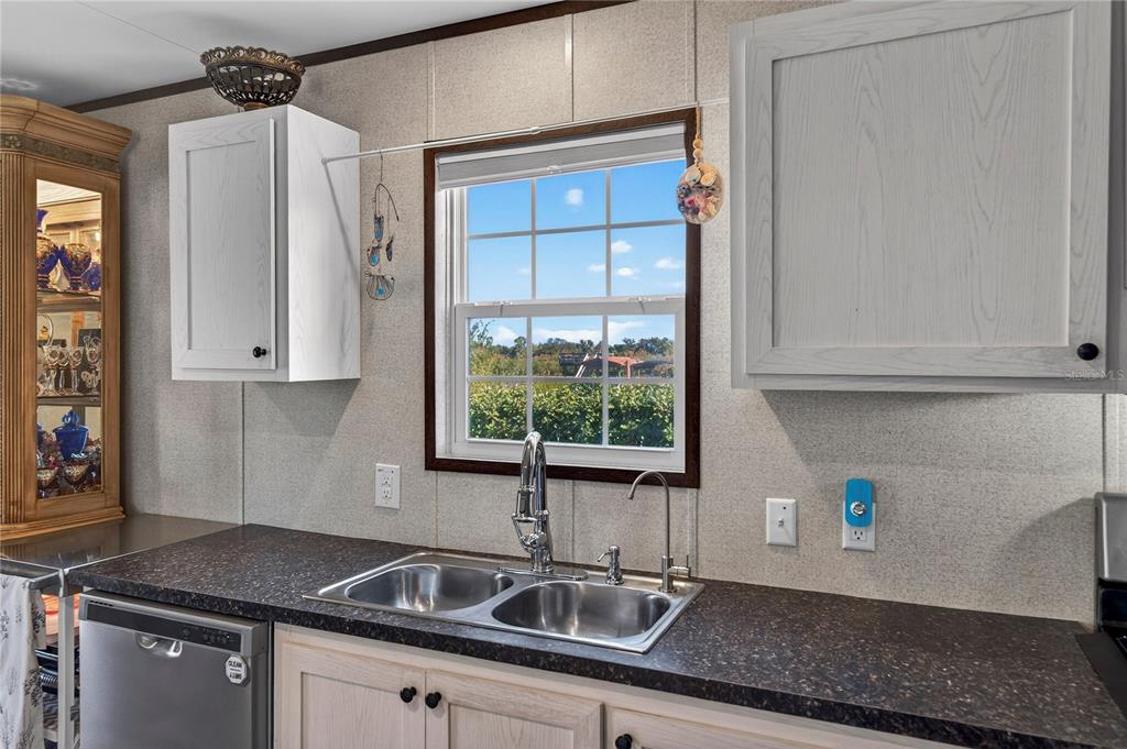 185 Coleman Street Edgewater, FL 32141 - Photo 14 of 47 a kitchen with stainless steel appliances granite countertop a sink and a cabinets