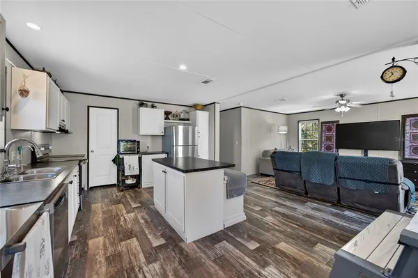 a kitchen with a refrigerator and a stove top oven
