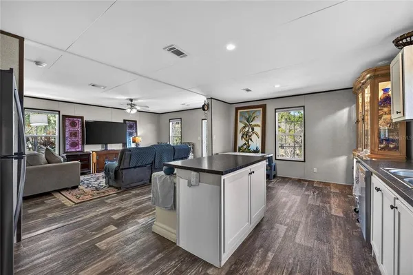 a living room with furniture a flat screen tv and a large window
