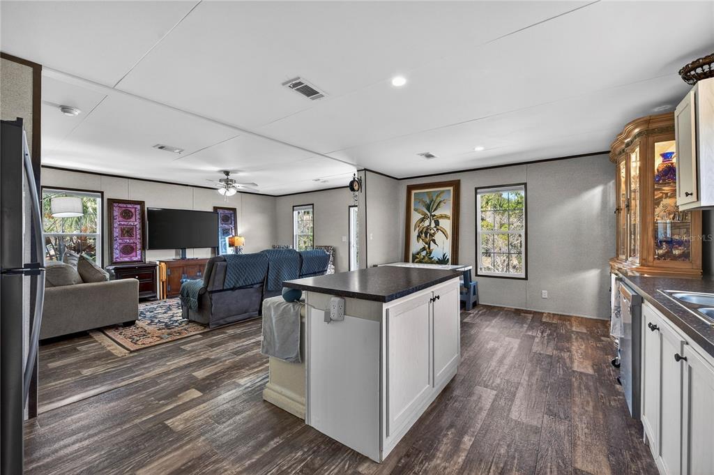 185 Coleman Street Edgewater, FL 32141 - Photo 17 of 47 a living room with furniture a flat screen tv and a large window