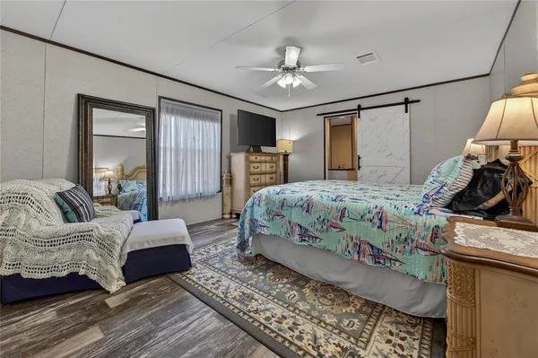 a bedroom with a large bed and a chandelier