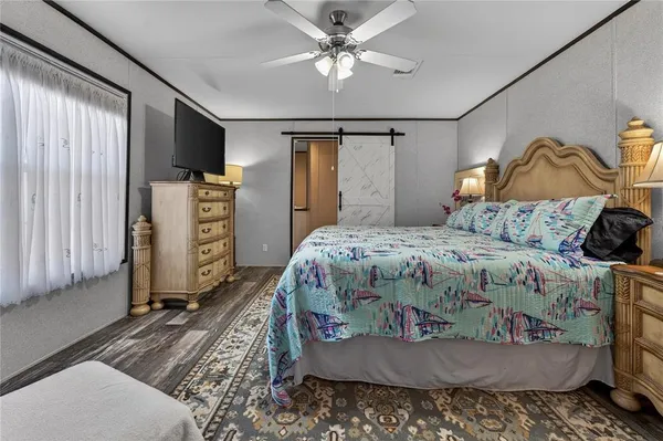 a bedroom with a bed and a chandelier