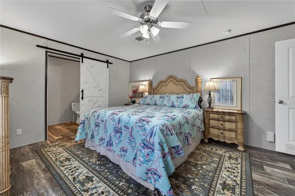 a bedroom with a bed and a chandelier