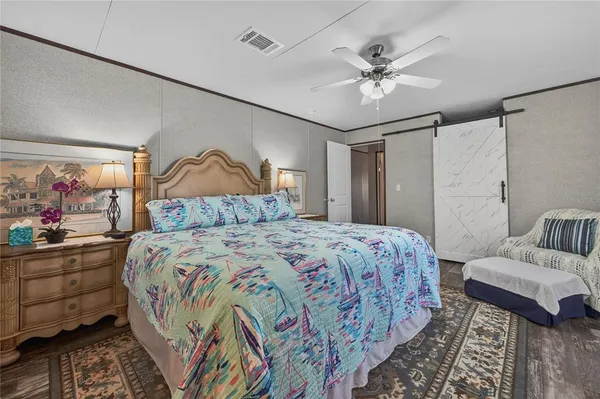 a bedroom with a bed and a chandelier