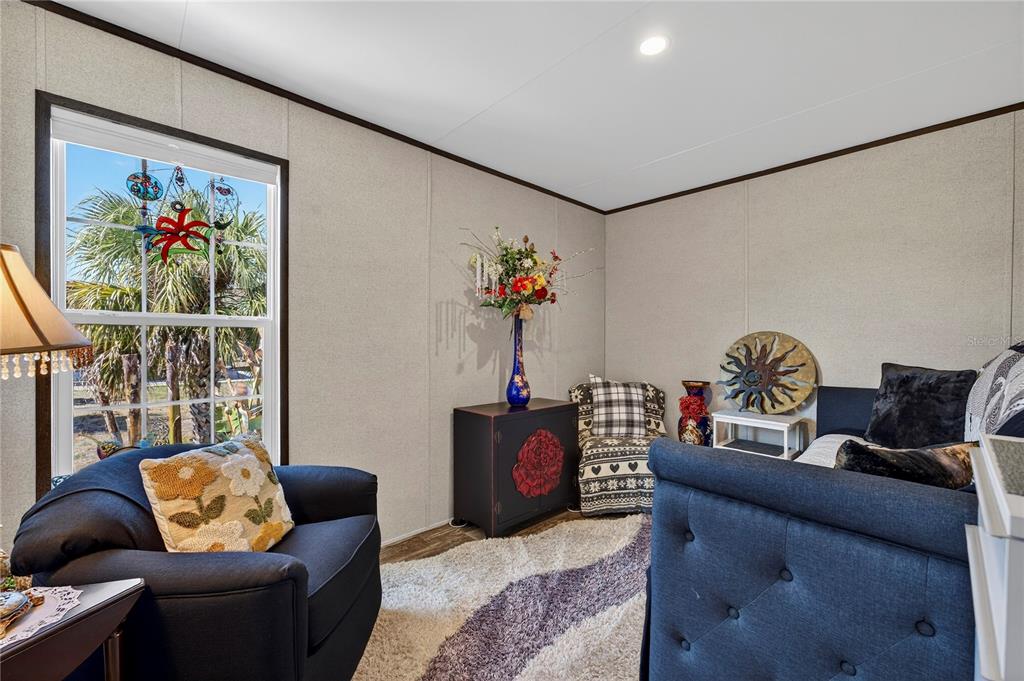 185 Coleman Street Edgewater, FL 32141 - Photo 32 of 47 a living room with furniture and a chandelier