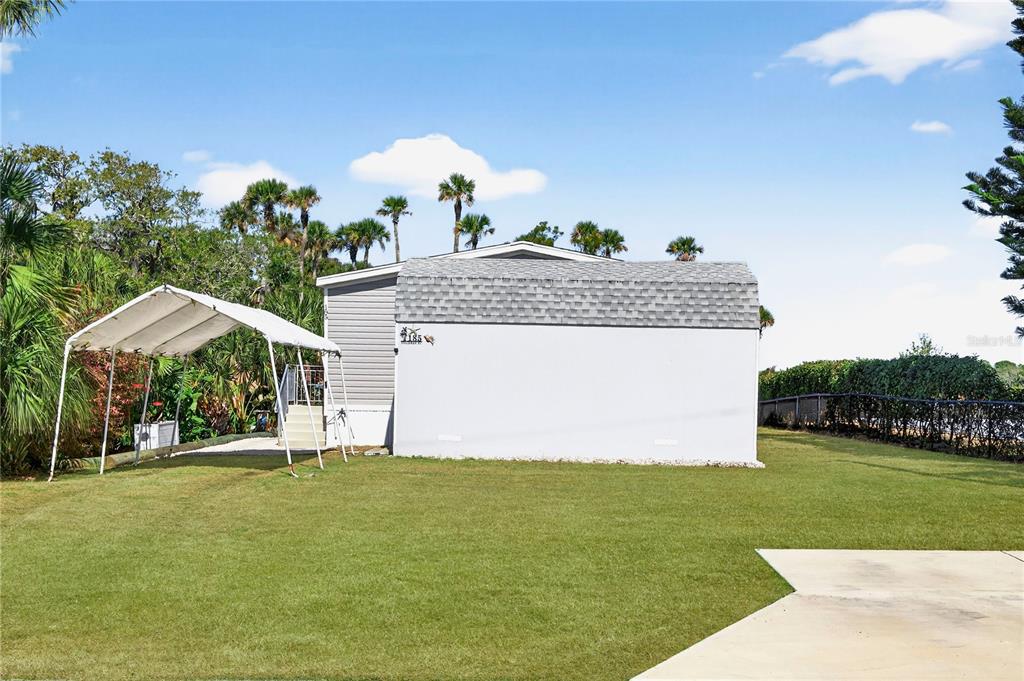 185 Coleman Street Edgewater, FL 32141 - Photo 37 of 47 a front view of a house with a garden and trees