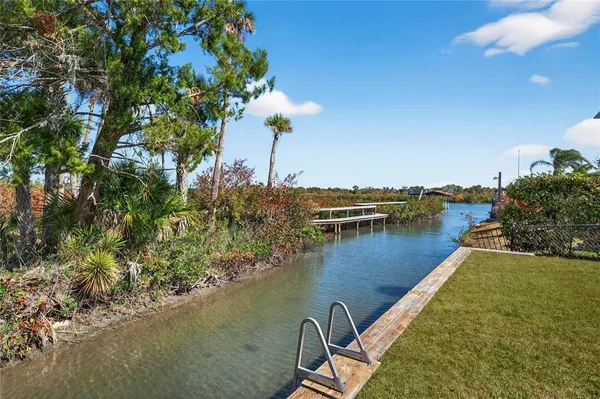 a view of a lake with a table and chairs