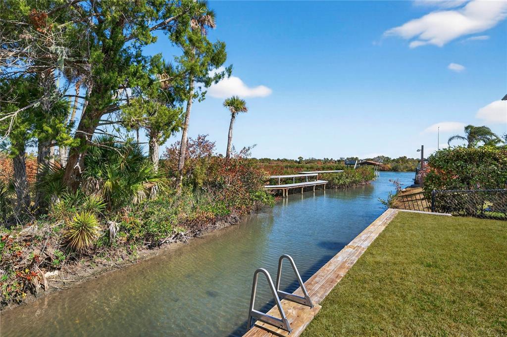 185 Coleman Street Edgewater, FL 32141 - Photo 4 of 47 a view of a lake with a table and chairs
