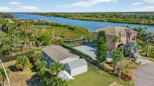 an aerial view of a house with garden space and a lake view
