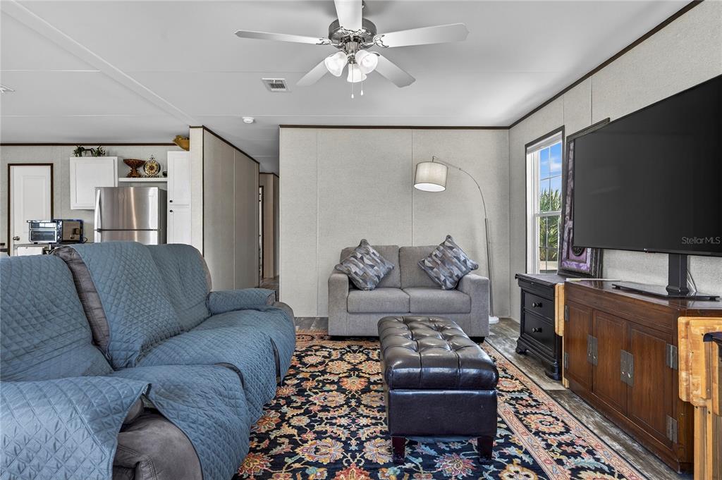 185 Coleman Street Edgewater, FL 32141 - Photo 6 of 47 a living room with furniture and a flat screen tv