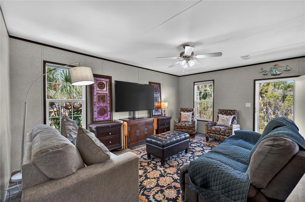 185 Coleman Street Edgewater, FL 32141 - Photo 7 of 47 a living room with furniture a large window and a flat screen tv