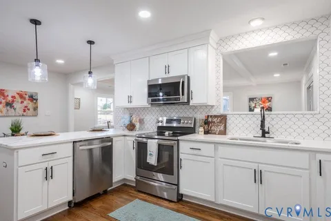 a kitchen with a sink stove and microwave
