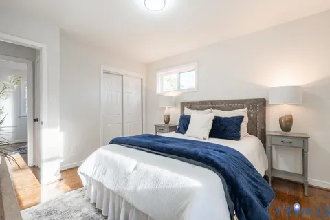 a bedroom with a bed and large mirror