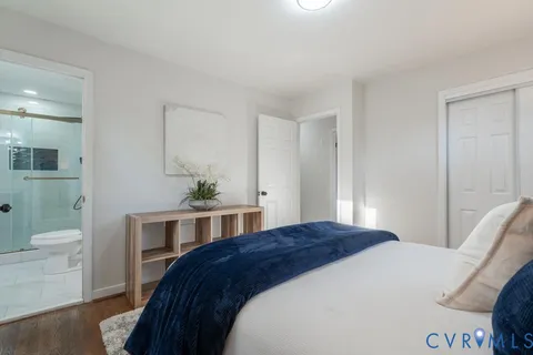 a bedroom with a bed and a potted plant