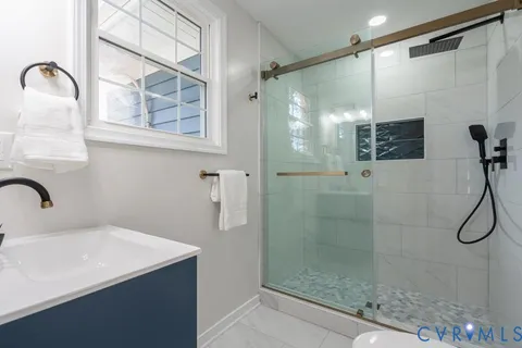 a bathroom with a shower and sink