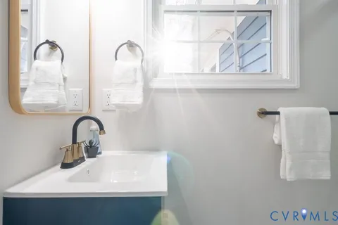 a bathroom with a sink and a window