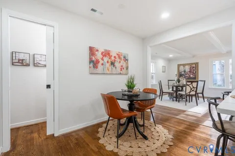 a view of a dining room with furniture and wooden floor