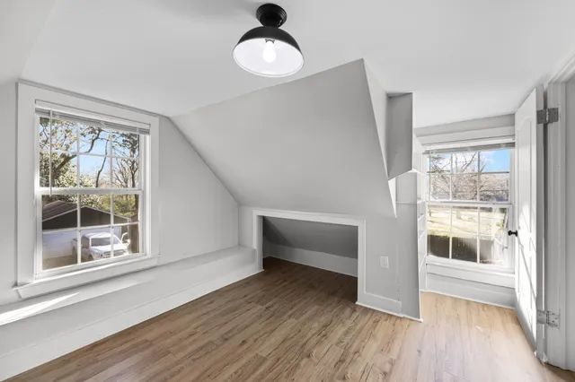 a view of a room with wooden floor and window