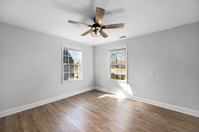 wooden floor in an empty room with a window